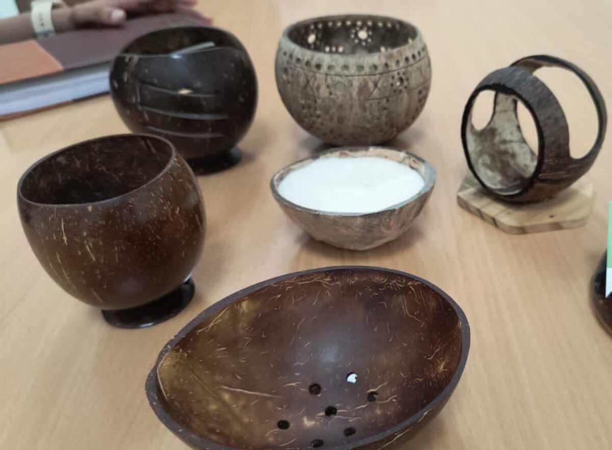 Collection of handcrafted coconut shell products including cups, bowls and a bangle