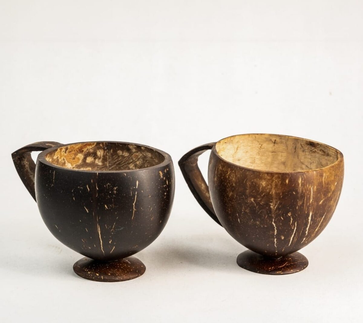 Handcrafted coconut shell cups with wooden handles