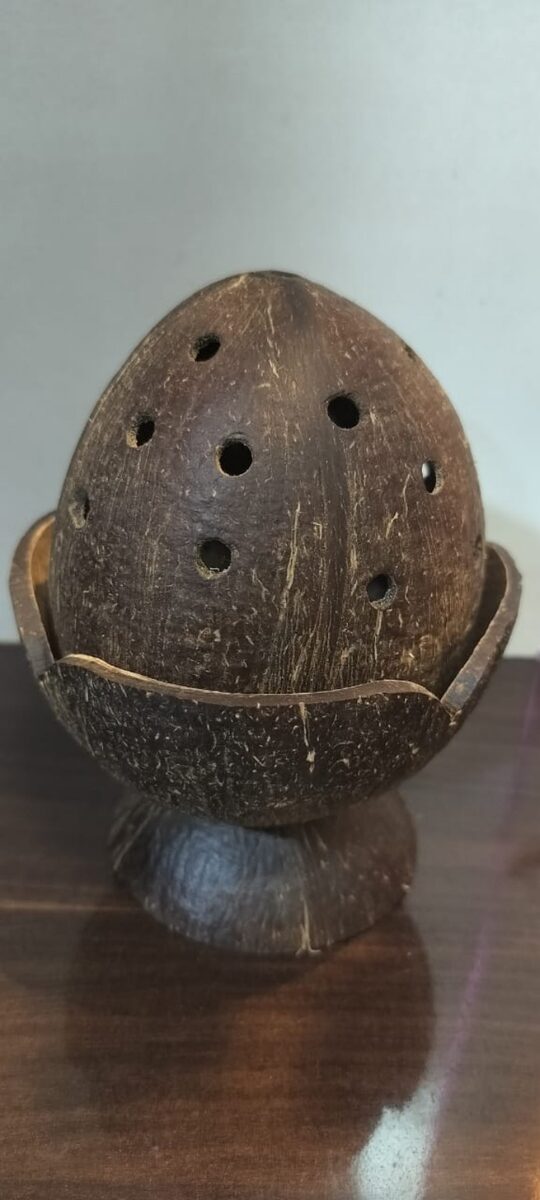 Carved coconut shell stand on a pedestal base